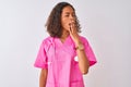 Young brazilian nurse woman wearing stethoscope standing over isolated white background bored yawning tired covering mouth with Royalty Free Stock Photo