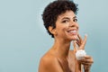 Young brazilian woman applying moisturizer Royalty Free Stock Photo