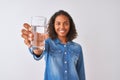 Young brazilian woman holding glass of water standing over isolated white background with a happy face standing and smiling with a Royalty Free Stock Photo