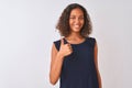 Young brazilian woman wearing blue dress standing over isolated white background doing happy thumbs up gesture with hand Royalty Free Stock Photo