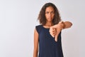 Young brazilian woman wearing blue dress standing over isolated white background looking unhappy and angry showing rejection and Royalty Free Stock Photo