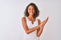 Young brazilian woman wearing casual t-shirt standing over isolated white background clapping and applauding happy and joyful, Royalty Free Stock Photo