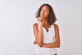 Young brazilian woman wearing casual t-shirt standing over isolated white background with hand on chin thinking about question, Royalty Free Stock Photo