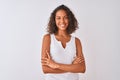 Young brazilian woman wearing casual t-shirt standing over isolated white background happy face smiling with crossed arms looking Royalty Free Stock Photo