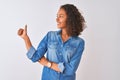 Young brazilian woman wearing denim shirt standing over isolated white background Looking proud, smiling doing thumbs up gesture Royalty Free Stock Photo