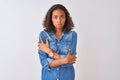 Young brazilian woman wearing denim shirt standing over isolated white background shaking and freezing for winter cold with sad Royalty Free Stock Photo