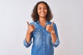 Young brazilian woman wearing denim shirt standing over isolated white background success sign doing positive gesture with hand, Royalty Free Stock Photo