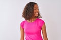 Young brazilian woman wearing pink t-shirt standing over isolated white background looking away to side with smile on face, Royalty Free Stock Photo