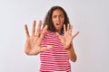 Young brazilian woman wearing red striped t-shirt standing over isolated white background afraid and terrified with fear Royalty Free Stock Photo