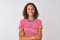 Young brazilian woman wearing red striped t-shirt standing over isolated white background happy face smiling with crossed arms Royalty Free Stock Photo