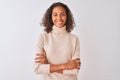 Young brazilian woman wearing turtleneck sweater standing over isolated white background happy face smiling with crossed arms Royalty Free Stock Photo