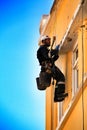 Young bricklayer climber doing repair work in a facade of Lisbon