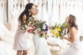 Young bride and bridesmaids holding tender flowers bouquets Royalty Free Stock Photo