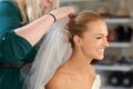 Placing those finishing touches. A young bride getting her hair done before the wedding. Royalty Free Stock Photo