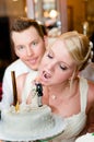 Young bride is going to bite her cake