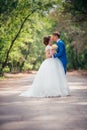 Young bride and groom embracing against the backdrop of the forest the road Royalty Free Stock Photo