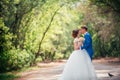 Young bride and groom embracing against the backdrop of the forest the road Royalty Free Stock Photo