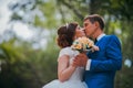 Young bride and groom kissing on the background of the forest Royalty Free Stock Photo