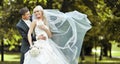 Young bride and groom laughing and looking to each other