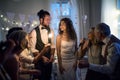 A young bride and groom with other guests dancing and singing on a wedding reception. Royalty Free Stock Photo