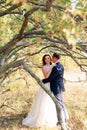 Young bride and groom walking in autumn Park with yellow leaves Royalty Free Stock Photo