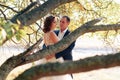 Young bride and groom walking in autumn Park with yellow leaves Royalty Free Stock Photo