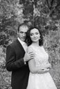 Young bride and groom walking in autumn Park with yellow leaves Royalty Free Stock Photo