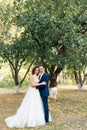 Young bride and groom walking in a summer Park with green trees Royalty Free Stock Photo