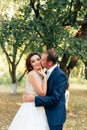 Young bride and groom walking in a summer Park with green trees Royalty Free Stock Photo