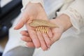 Young bride hands holding a piece of hair ornament shape as a golden w