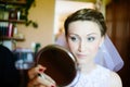Young bride looking into mirror. Royalty Free Stock Photo