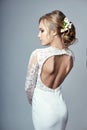Young bride in a luxurious white wedding dress and beautiful hair. Woman before the wedding ceremony, a perfect figure Royalty Free Stock Photo