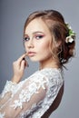 Young bride in a luxurious white wedding dress and beautiful hair. Woman before the wedding ceremony, a perfect figure of bride Royalty Free Stock Photo