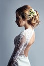 Young bride in a luxurious white wedding dress and beautiful hair. Woman before the wedding ceremony, a perfect figure Royalty Free Stock Photo