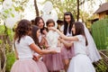 Young bride opens the gift box at girls party