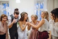 A young bride with other guests dancing and singing on a wedding reception. Royalty Free Stock Photo
