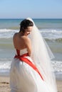 Young bride outdoor portrait in white dress against seascape Royalty Free Stock Photo