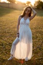 Young bride posing alone in the field