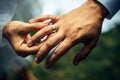 Young bride put a gold wedding ring on the groom`s finger, close-up. Wedding ceremony, exchange of rings. On the hand of man