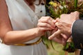 Young bride put wedding ring on the groom`s finger with difficulties, close-up. Wedding ceremony, hardly exchanging. Future Royalty Free Stock Photo