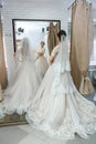 Young bride in salon looking in mirror at her reflection Royalty Free Stock Photo