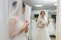 Young bride in salon looking in mirror at her reflection Royalty Free Stock Photo
