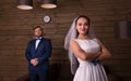 Young bride and serious groom on photo shoot Royalty Free Stock Photo