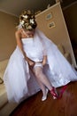 Young bride setting the garter Royalty Free Stock Photo