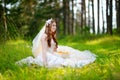 Young bride sitting on a grass Royalty Free Stock Photo