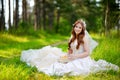 Young bride sitting on a grass Royalty Free Stock Photo