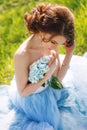 Young bride sitting on the grass in the park Royalty Free Stock Photo