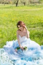 young bride sitting on the grass in the park Royalty Free Stock Photo