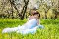 young bride sitting on the grass in the park Royalty Free Stock Photo