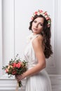 Young bride in wedding dress holding bouquet Royalty Free Stock Photo